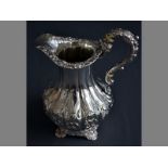 A VICTORIAN SILVER CREAMER LONDON 1856, STEPHEN SMITH & WILLIAM NICHOLSON embossed scroll handle,