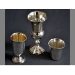 A COLLECTION OF THREE RUSSIAN .84STD SILVER KIDDUSH CUPS fold-over rim, body prick work engraved