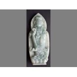 A MODERN CHINESE HARDSTONE CARVING DEPICTING A FIGURE OF KWAN YIN standing on a lotus base,