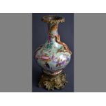 A FINE CHINESE FAMILLE ROSE AND CELADON BOTTLE VASE in French ormolu mounts, decorated with mythical