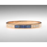 Ladies' Sapphire and Diamond Bangle 18k yellow gold hinged bangle bracelet, beveled top featuring