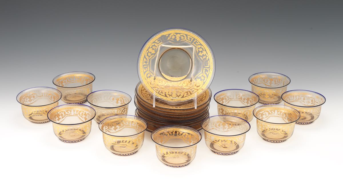 Twelve Moser Smoked Topaz Glass Gilt/Bejeweled Underplates and Eleven Finger Bowls nullTotal 23 hand