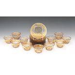 Twelve Moser Smoked Topaz Glass Gilt/Bejeweled Underplates and Eleven Finger Bowls nullTotal 23 hand