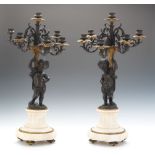 A Pair of Bronze Putto Candelabra 25"Louis XV style patinated bronze candelabra with a central