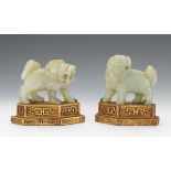 Two Carved Celadon Jade Lions 5" x 4-3/4"Chinese carved celadon jade lions on gilt base. Both