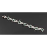 Ladies' Platinum, Diamond and Emerald Bracelet  7-1/2" Platinum floriform bracelet with slide-in