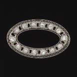 Edwardian Platinum and Diamond Brooch  1-Â½ x 1 in. Platinum filigree open oval shape brooch with