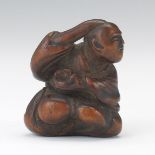 Netsuke of a Seated Man 1-5/8"Carved wood netsuke of a seated, confused man. Unsigned. Online