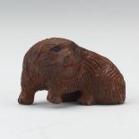 Carved Netsuke of a Dog 1" x 1-5/8"Carved wood netsuke of a dog, signed on the bottom.  Online