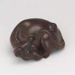 Carved Netsuke of a Recumbent Ox 7/8" x 1-3/4"Carved wood of an ox. Signed on bottom. Online Bidding