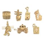 A Group of Seven Gold Charms  1 inch to 1/2 inch 14k yellow gold charms including: a windmill, a