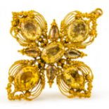 A gold and precious topaz filigree pendant/brooch. Width 4cm, Wt. 9.2g.