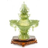 An antique Chinese serpentine incense holder, with a carved wooden stand, height 29.5cm.