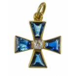 A gold diamond and sapphire miniature Maltese cross. Est. Sapphire Wt. 2ct. Est. Dia. Wt. 0.20ct.