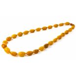 A natural Baltic amber bead necklace, bead size from 30mm x 18mm to 23mm x 15mm, length 76cm, Wt.