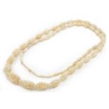 An antique carved ivory necklace, length 102cm, Wt. 55.3g