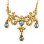 A gold, aquamarine and ½ pearl necklace on a gold trace link chain. Pendant length 5cm, chain length