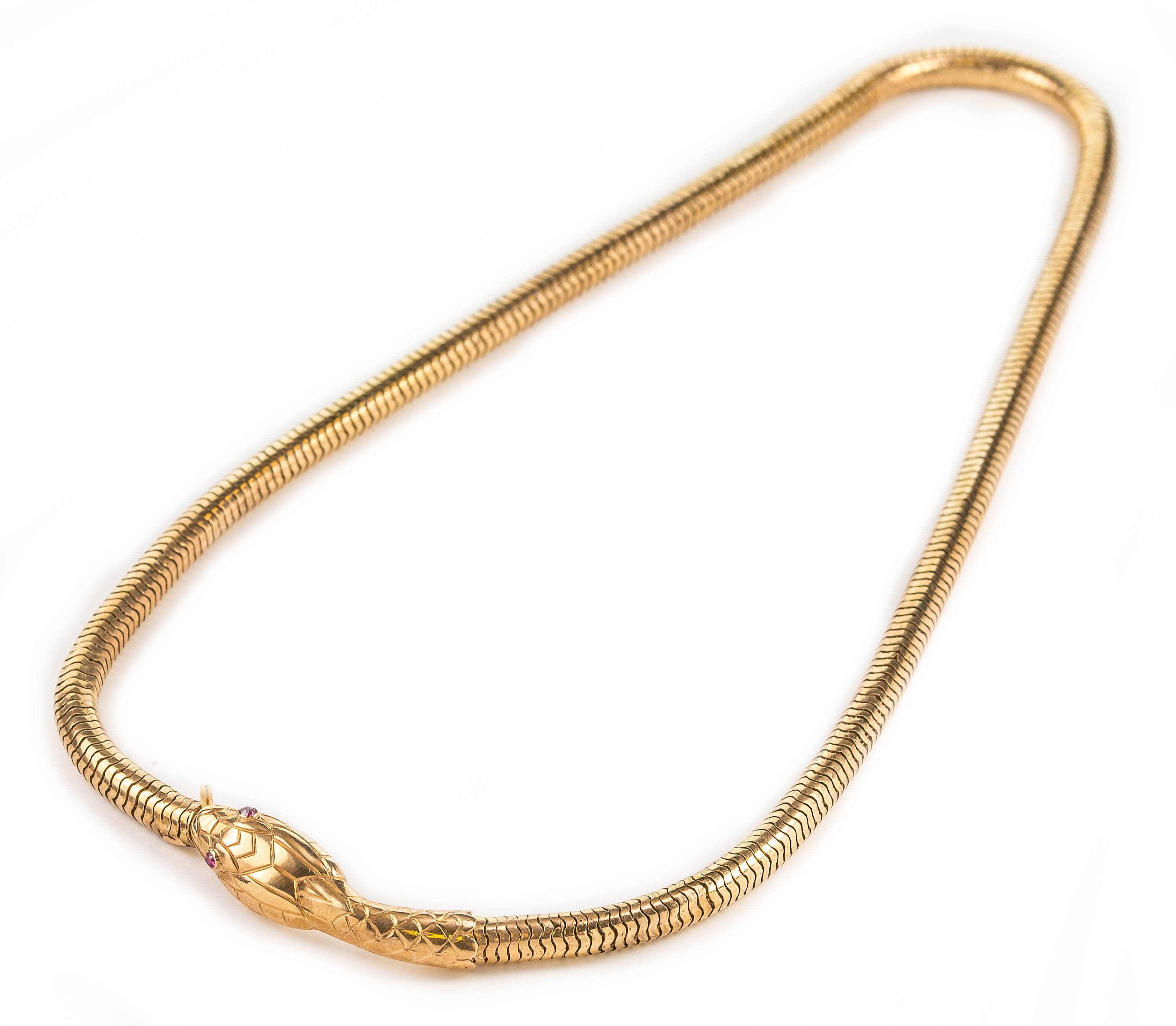 An antique gold and ruby eye snake necklace, length 43cm, Wt. 28.3g.