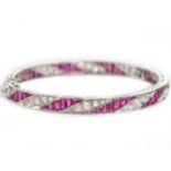 A white gold, ruby and diamond bangle, Est. 1.60ct rubies, width 6cm, Wt. 15.2g