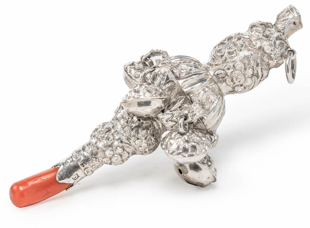 A Victorian George Unite silver and coral rattle, length 10cm Wt. 50g.