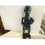 A Benin bronze figure of a warrior with sword and enemies head. Approx 500 mm tall.