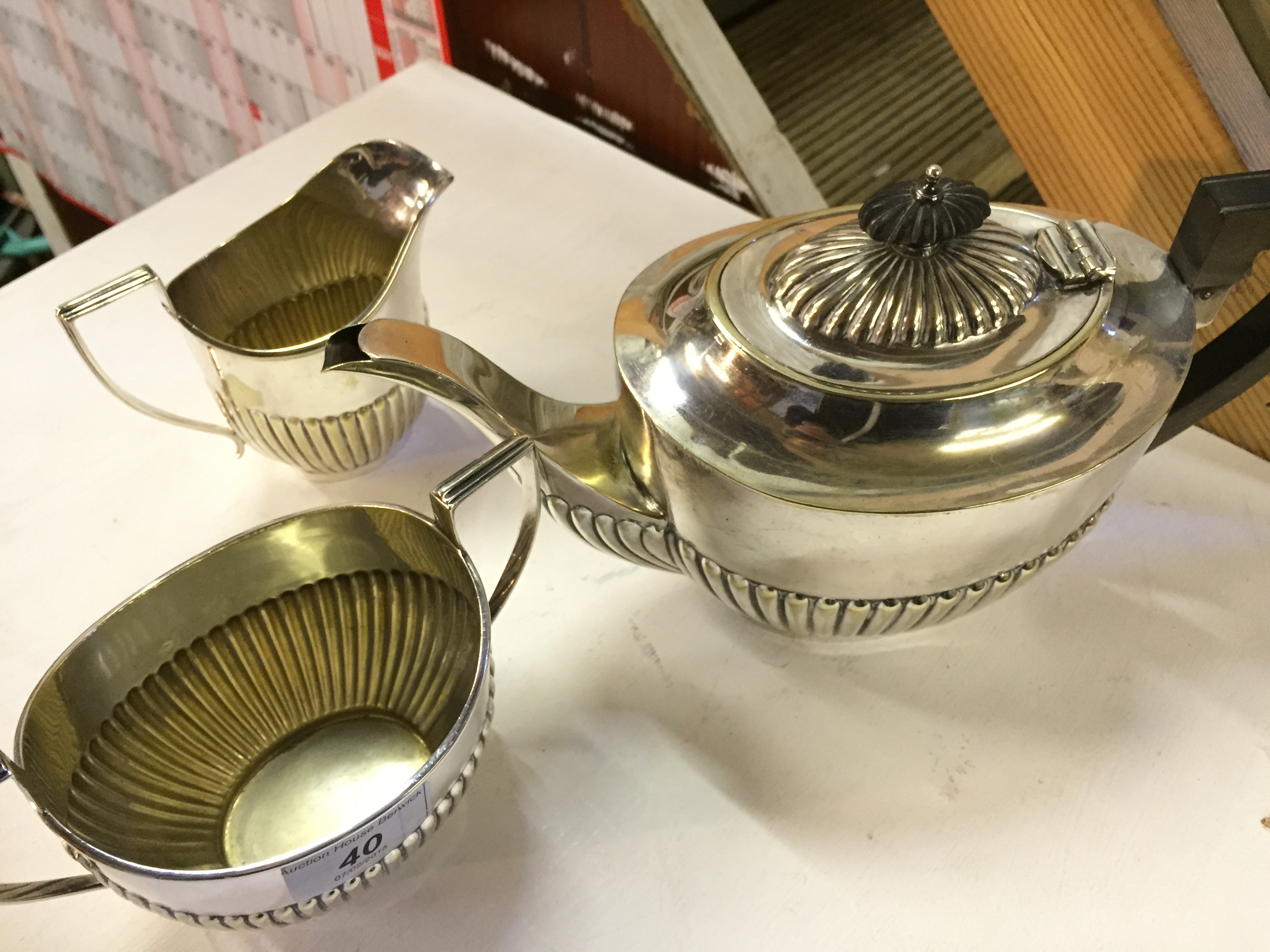 A silver plate tea pot sugar bowl and mi