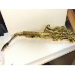 A saxophone with carry case and music st