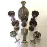 A studio pottery wine carafe and six goblets and two silver plate goblets.