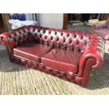 *A leather Chesterfield sofa bed.