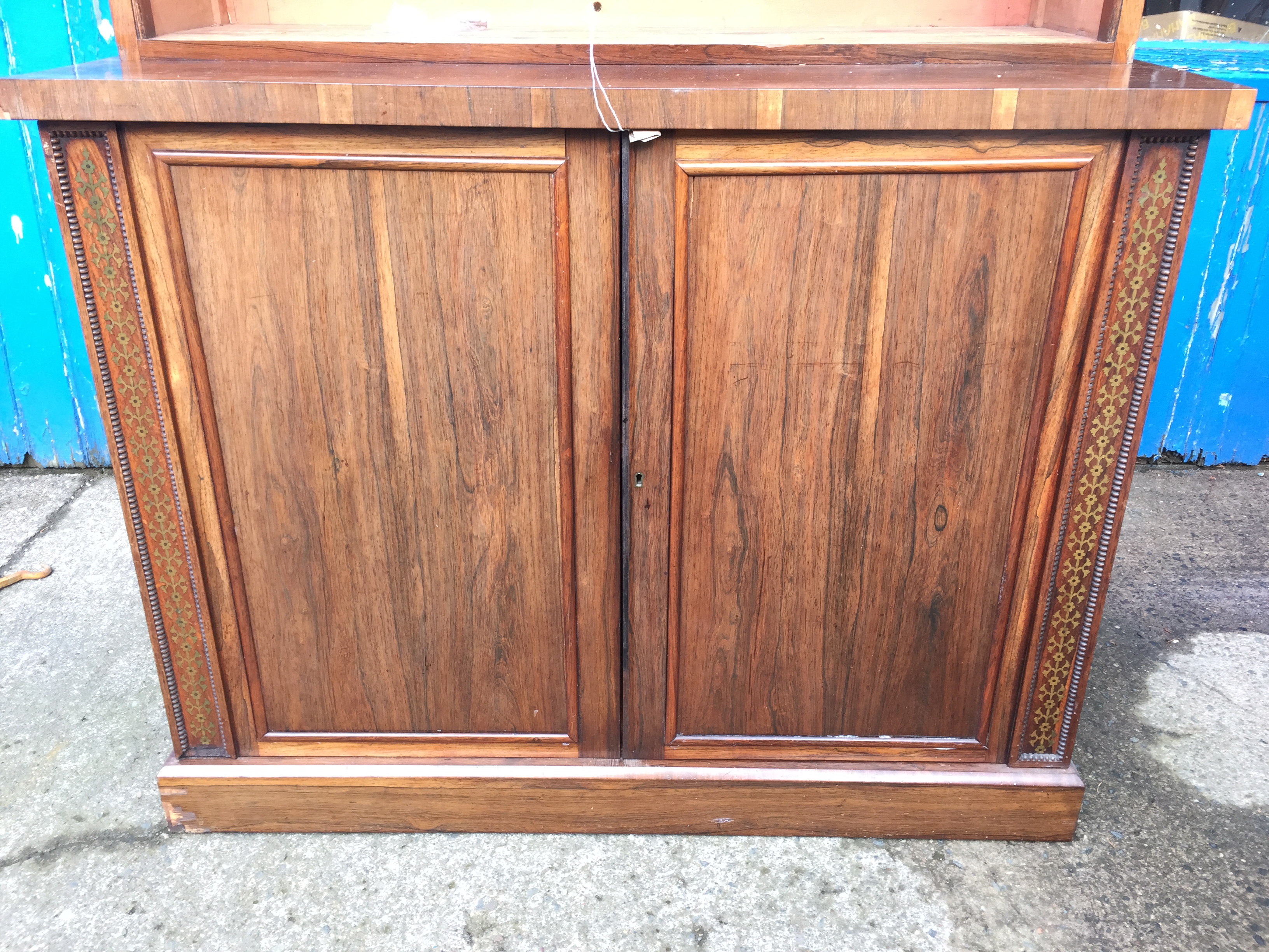 A large bookcase cabinet inlaid with brass and having ratcheted shelves and cupboards below 1220 - Image 2 of 9