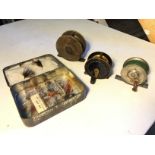 Three fishing reels and a selection of flies including Hardys