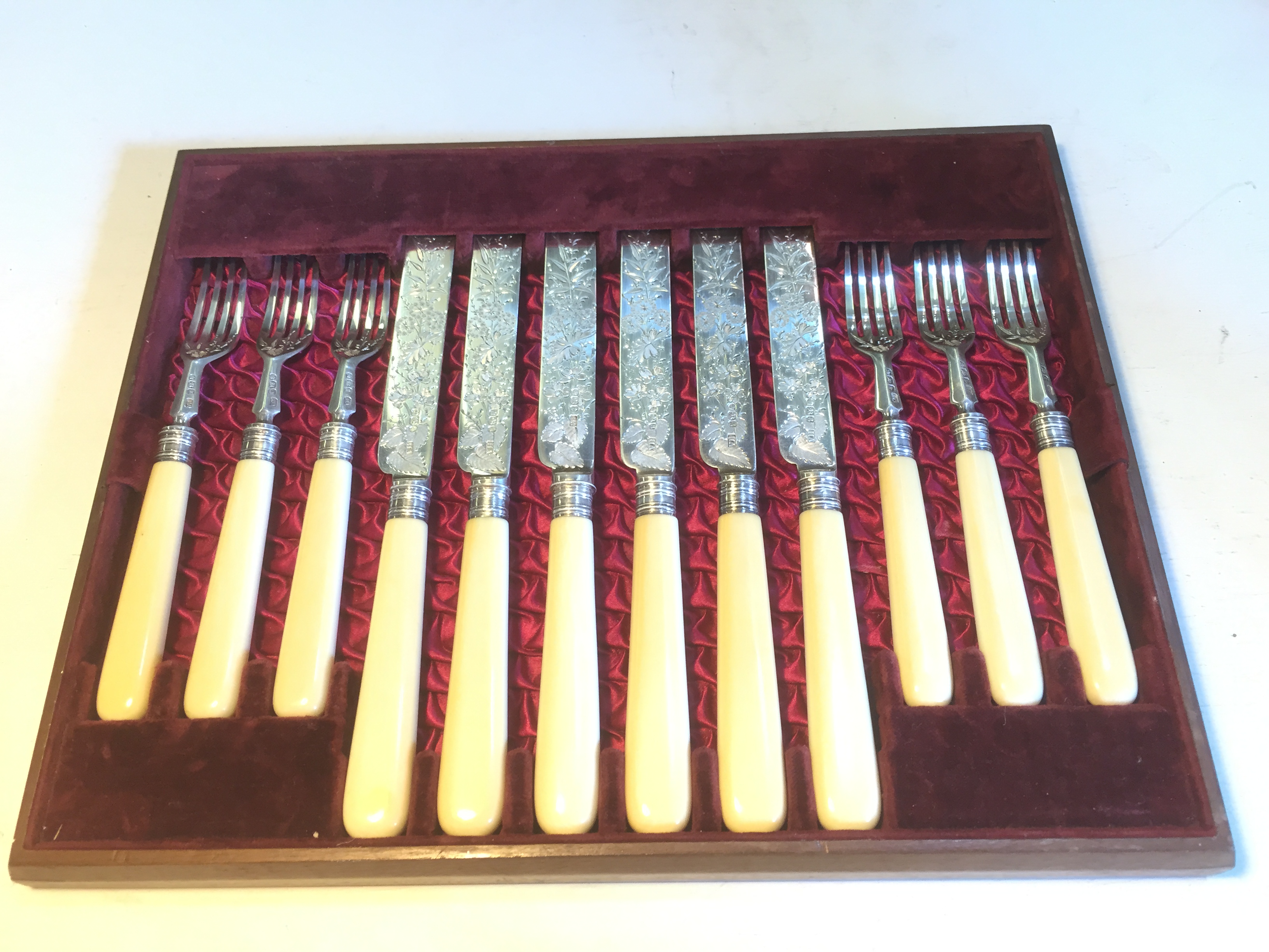 A set of siver knives and forks marked Sheffield