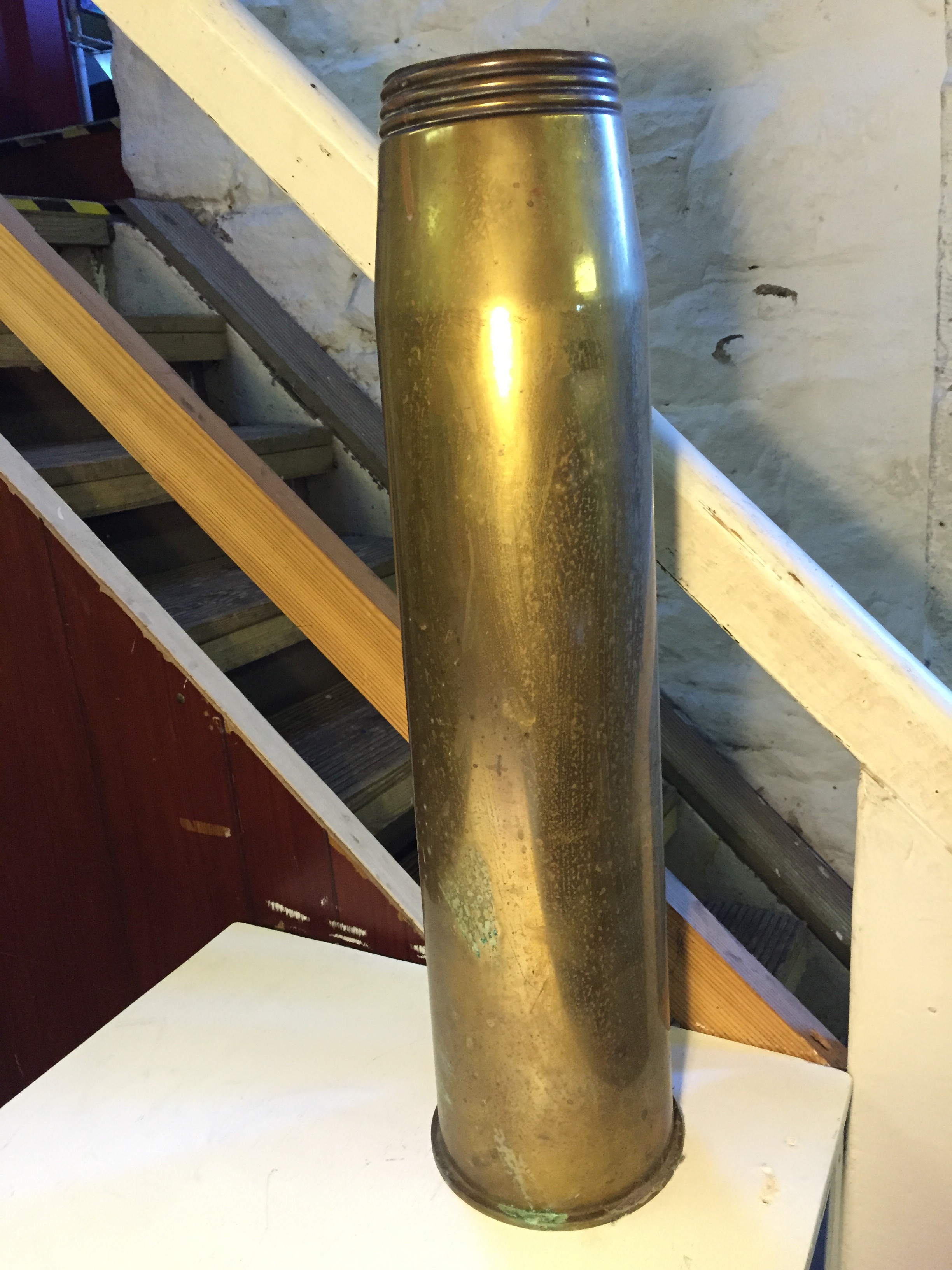 A brass cartridge shell 650 mm high.