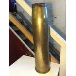 A brass cartridge shell 650 mm high.