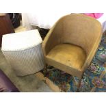 A whicker lloyd loom sprung chair and laundry basket.