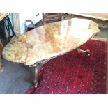 A marble coffee table with gilt metal legs.