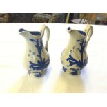 A pair of ceramic blue and white jugs.