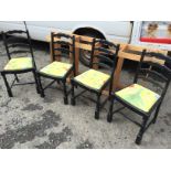 Four ladder back dining chairs