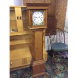 A grandmother clock in a well made reproduction case with a repainted face.