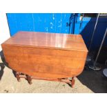 A drop leaf oak table.