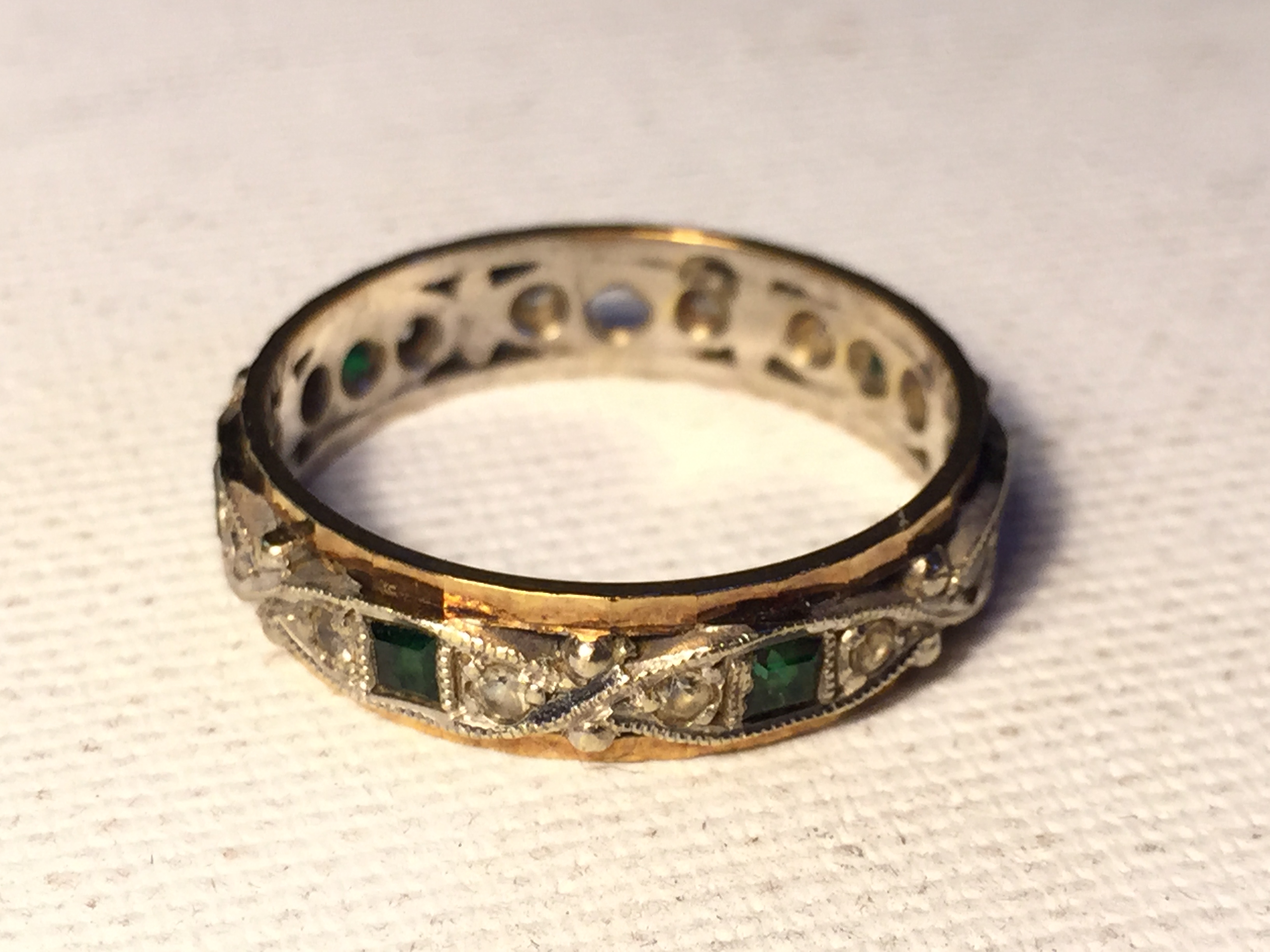 A diamond and emerald ring one emerald inset missing. 3.4 g