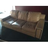 *A large beige leather sofa which dismantles for moving.