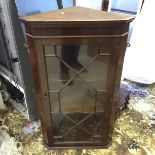 A wall hung corner cabinet.