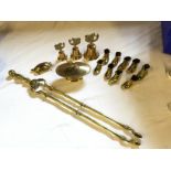 A selection of brass ware including a pair of large fire tongs, a covered bowl,