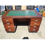 An double pedestal office desk with leather top and brass handles.