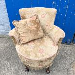 A small upholstered boudoir chair.