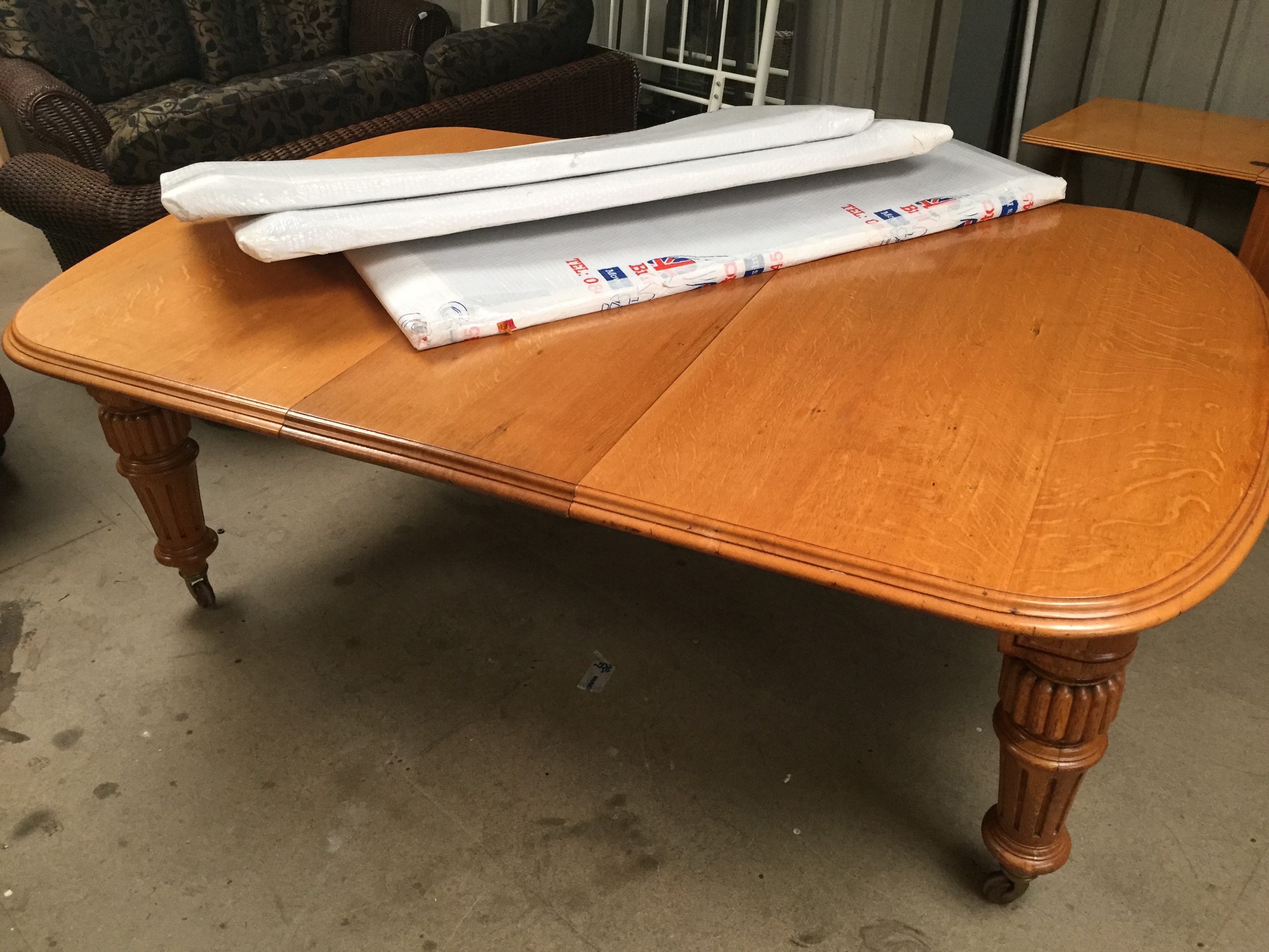 * A large Victorian light oak extending table with winding mechanism.