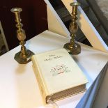 A bible and a pair of candlesticks