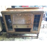 An bureau bookcase with side glass panelled doors.