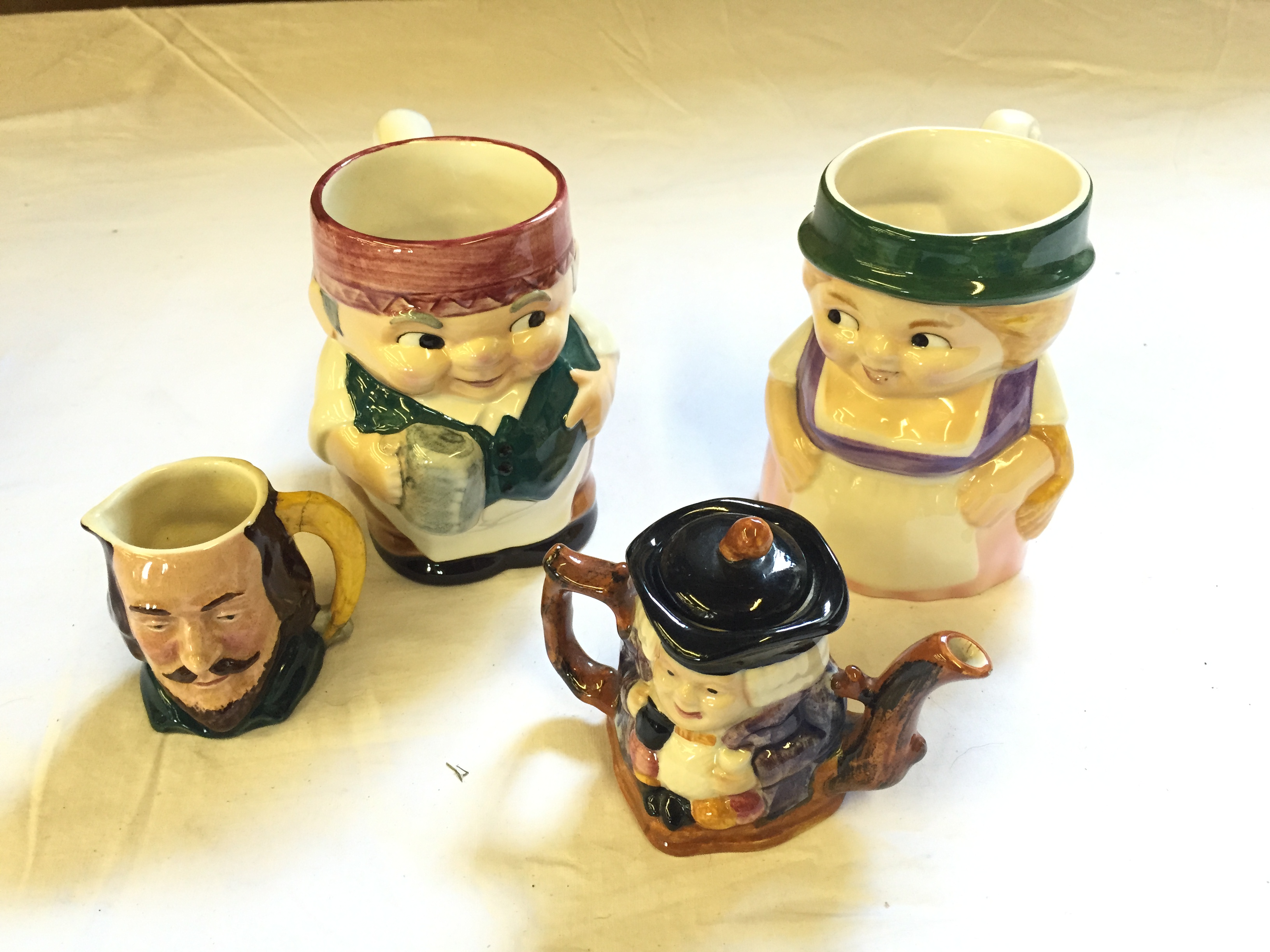 Two Goebel tankards a Shorrter and Son tea pot and a Sandland Toby Jug with cracked handle.